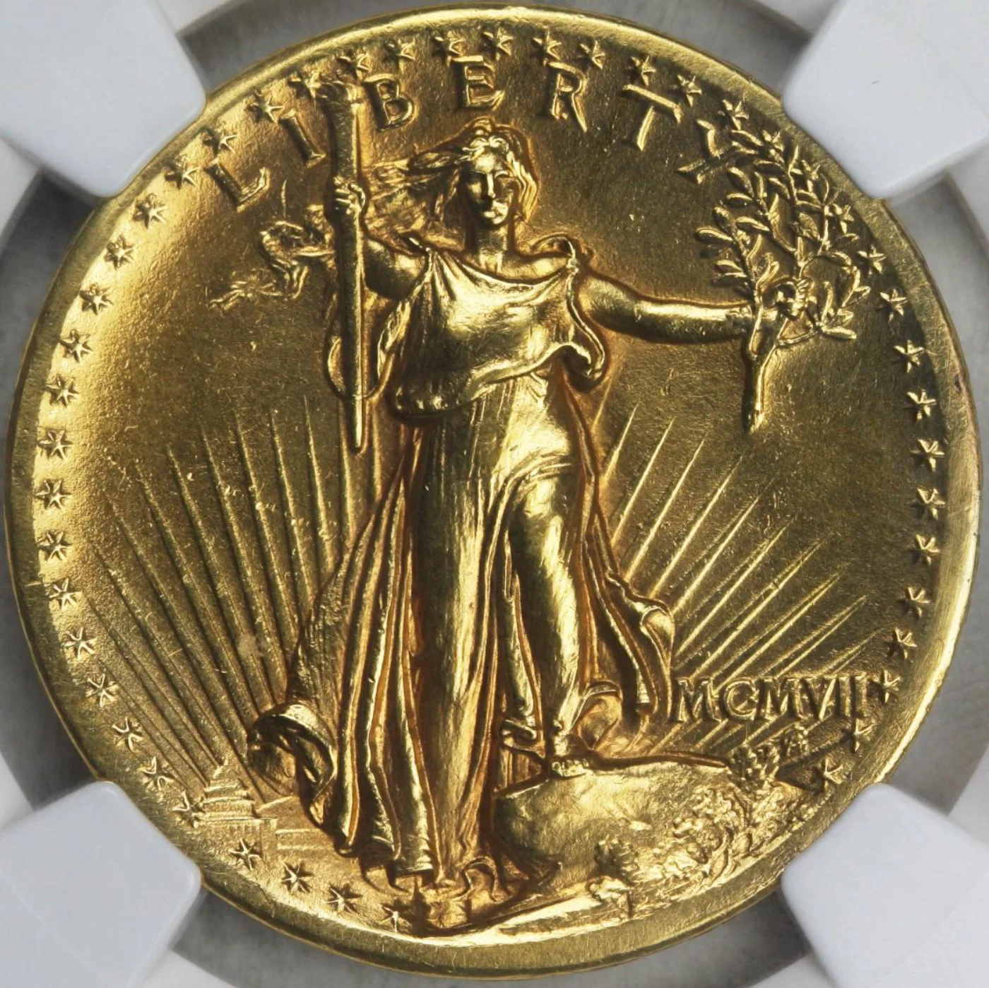 Obverse of a 1907 High Relief double eagle in a grading holder, with deeply sculpted relief and MCMVII at lower right