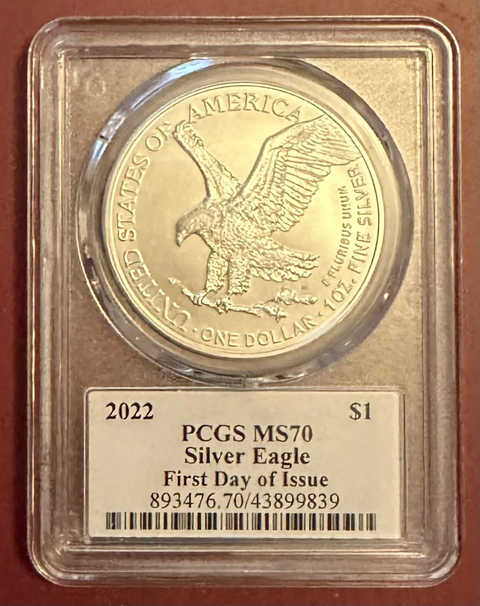 Type 2 reverse of a 2022 American Silver Eagle in a PCGS holder, showing a naturalistic eagle descending with an oak branch