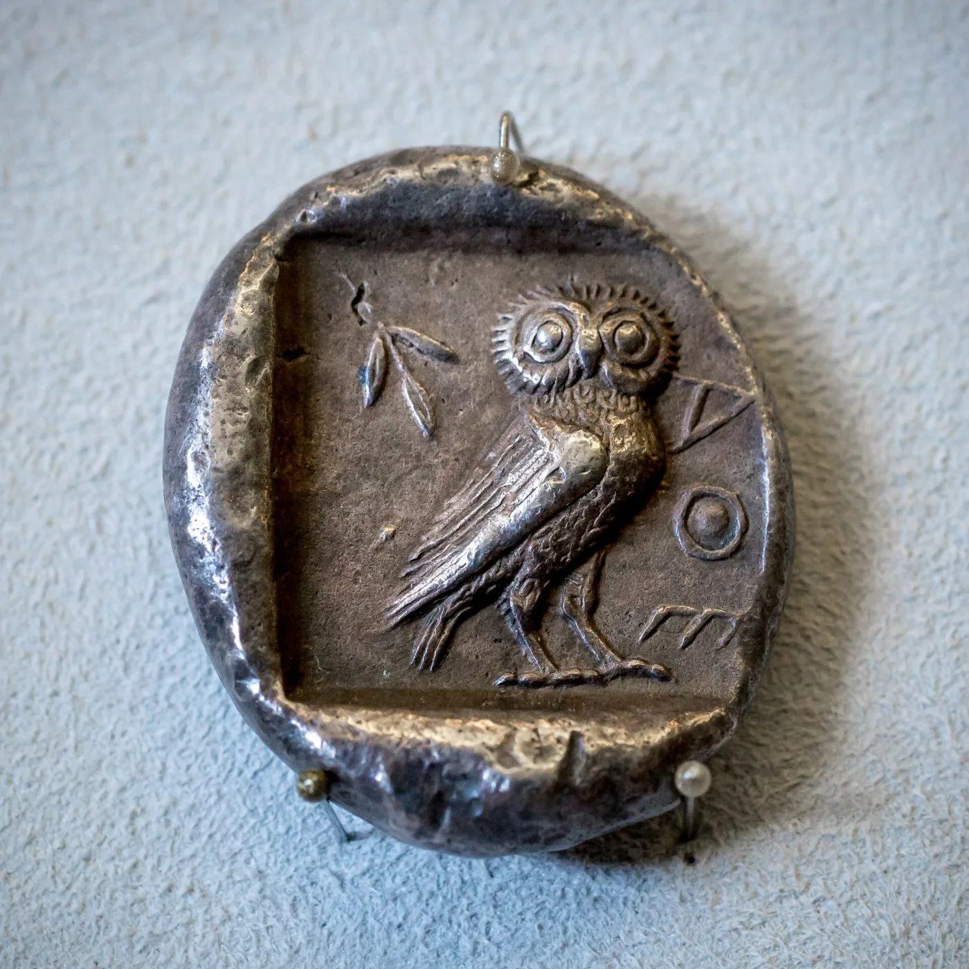 Reverse of an early Athenian silver tetradrachm, an owl standing inside a clearly visible sunken square field