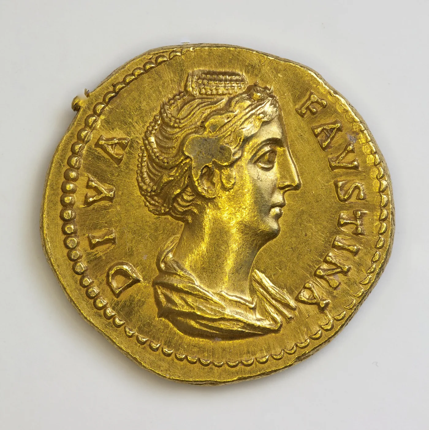 Obverse of a Roman gold aureus, a draped female bust facing right with the legend DIVA FAVSTINA around a beaded border