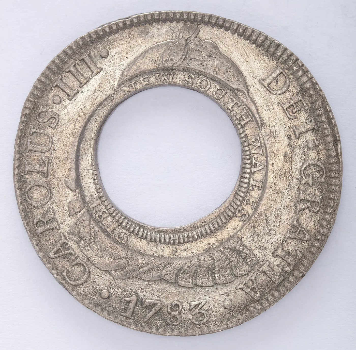 A New South Wales holey dollar, a Spanish silver eight reales of 1783 with its centre punched out and NEW SOUTH WALES 1813 struck around the hole