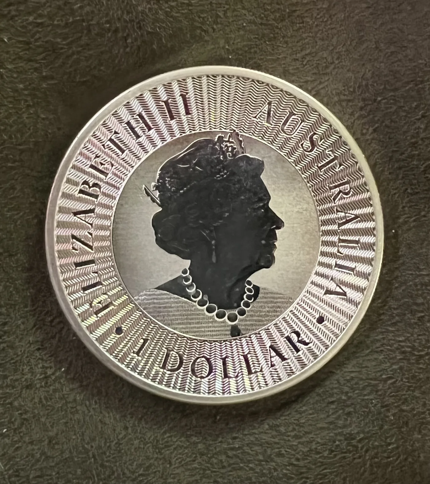 A large modern silver bullion coin showing a kangaroo in profile with the year and weight around it