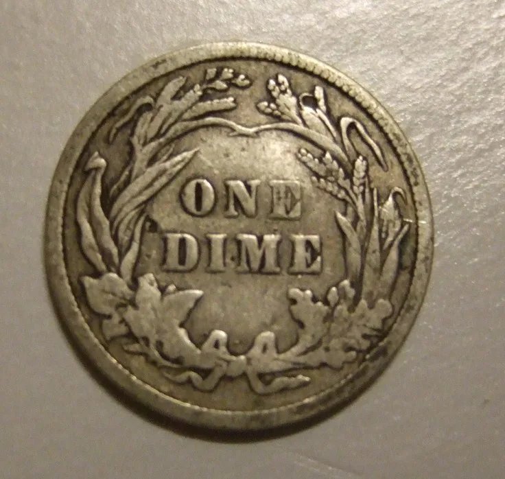Reverse of a well-circulated 1908 Barber dime with the wreath leaves worn smooth and ONE DIME still bold