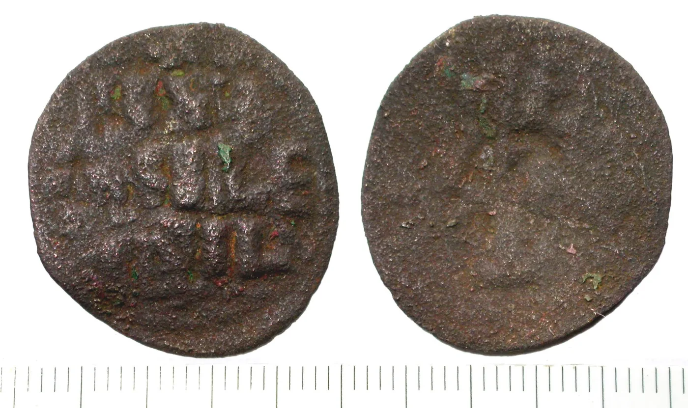Obverse and reverse of a Byzantine copper follis, one side a worn facing bust and the other three lines of Greek capitals