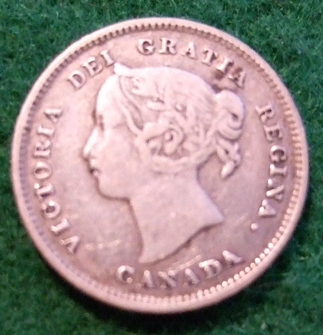 A small silver Canadian five cent coin showing a crowned profile of Queen Victoria with the legend VICTORIA DEI GRATIA REGINA and CANADA below