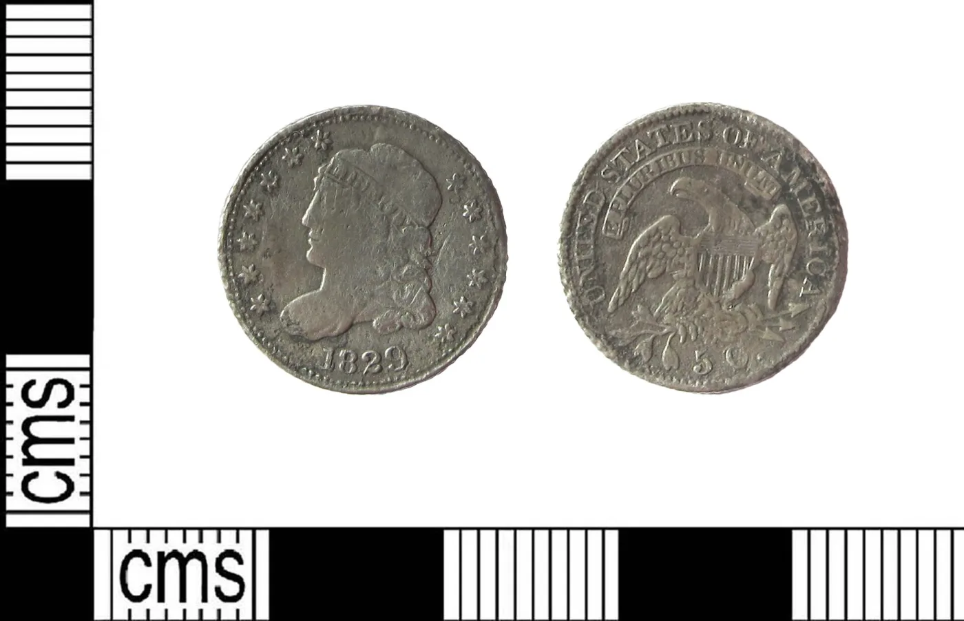 Circulated 1829 Capped Bust half dime photographed obverse and reverse beside a centimetre scale bar, the coin measuring about a centimetre and a half across