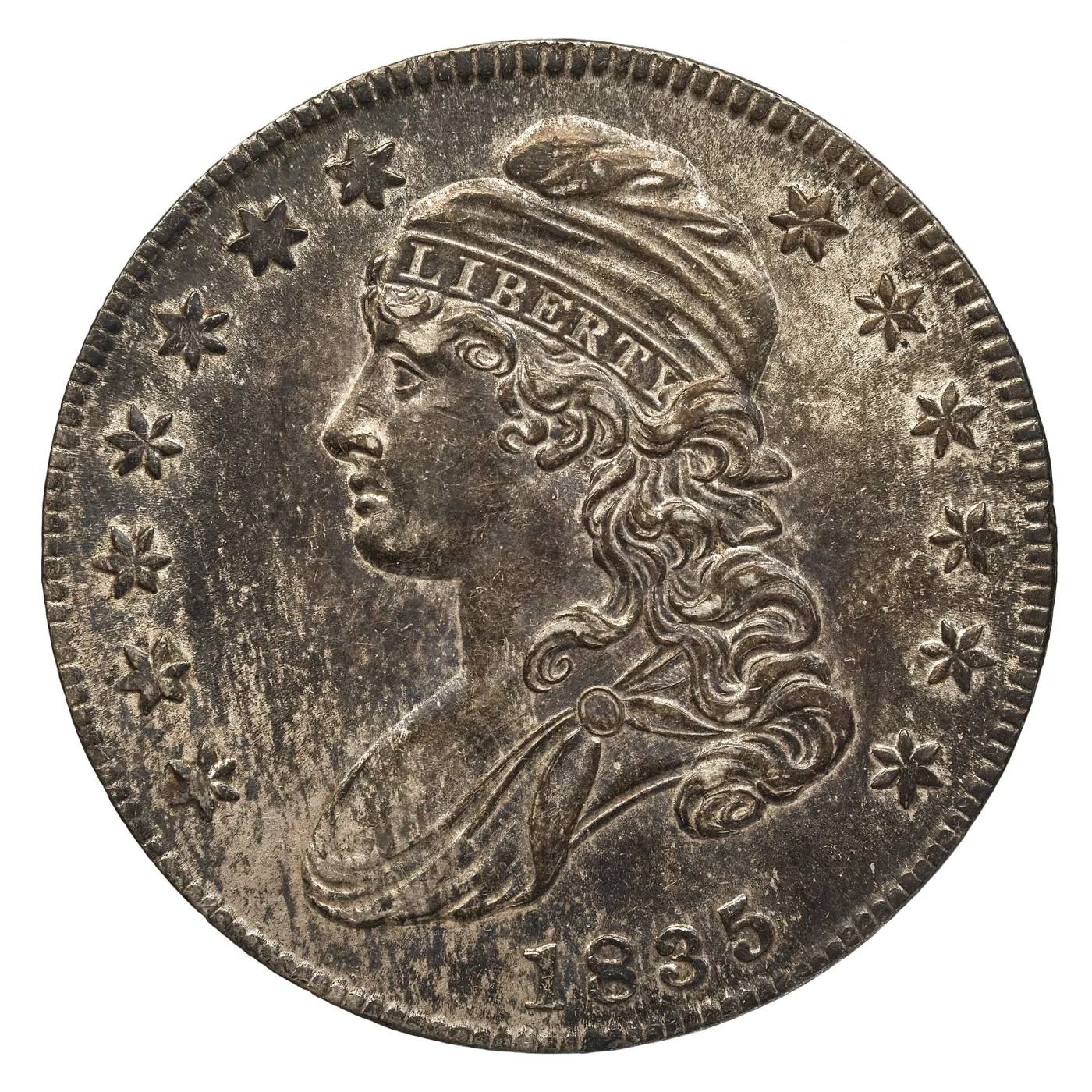 Obverse of an 1835 Capped Bust half dollar in a middle circulated grade, with the LIBERTY cap band still complete and hair curls partly worn