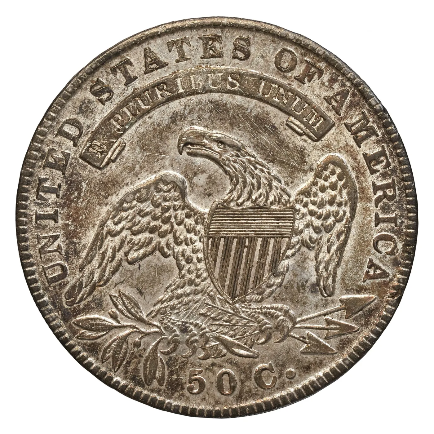 Reverse of the same 1835 Capped Bust half dollar, with the horizontal shield lines and the eagle's wing feathers still separated