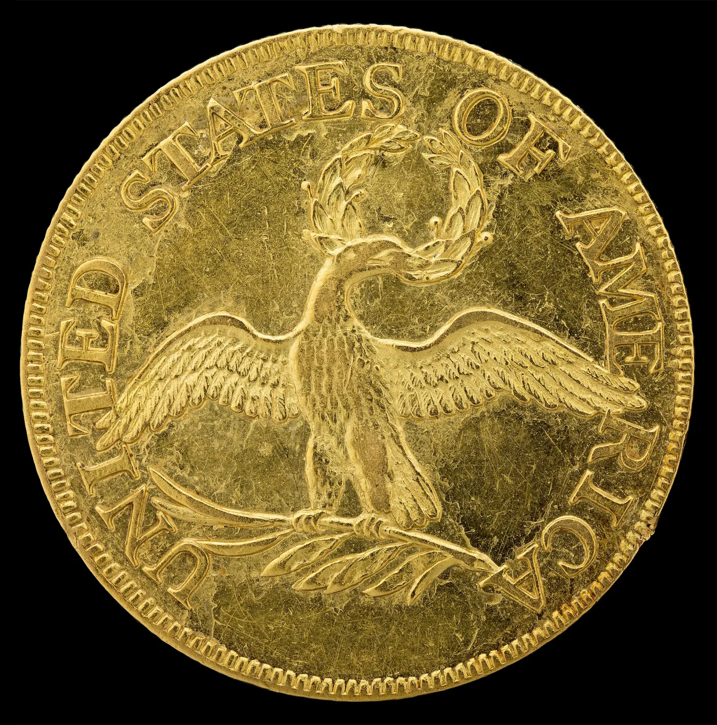 Small eagle reverse of a 1795 half eagle showing a slender eagle standing on a palm branch with a wreath in its beak and no shield