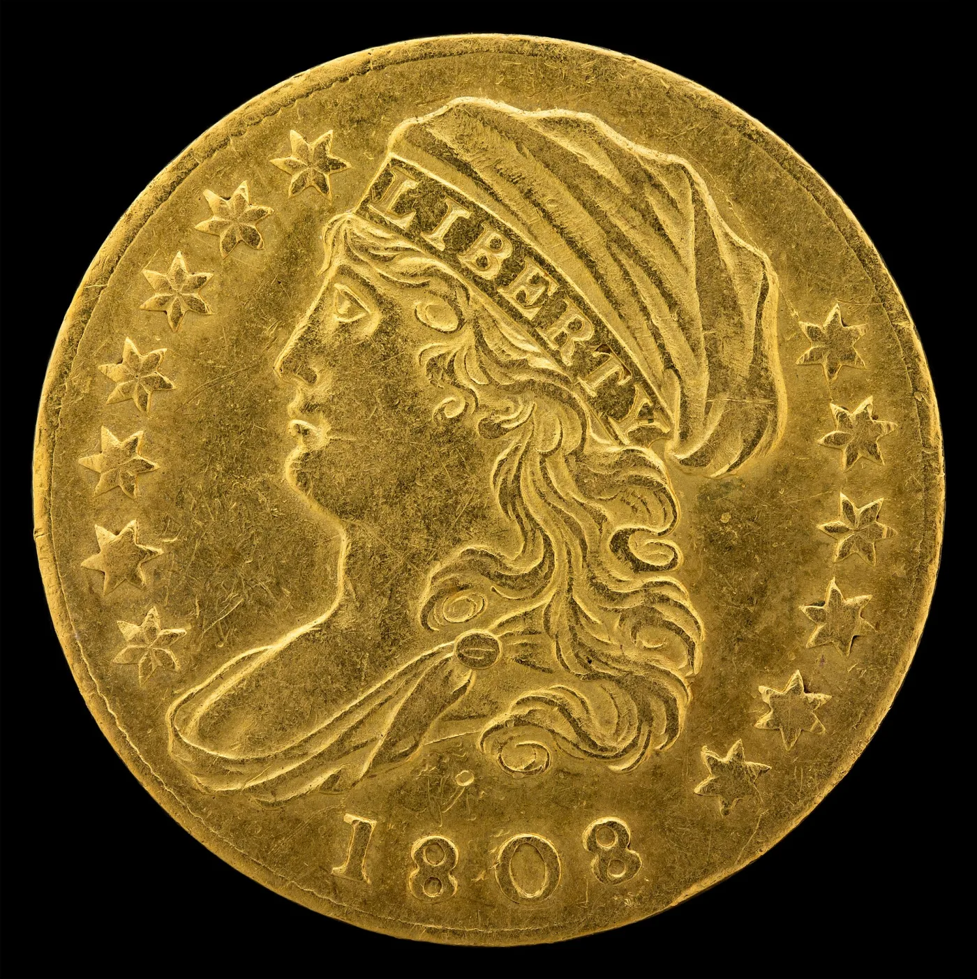 Obverse of an 1808 quarter eagle showing Liberty in a cap facing left, LIBERTY lettered along the cap band, stars around the field and the date 1808 below