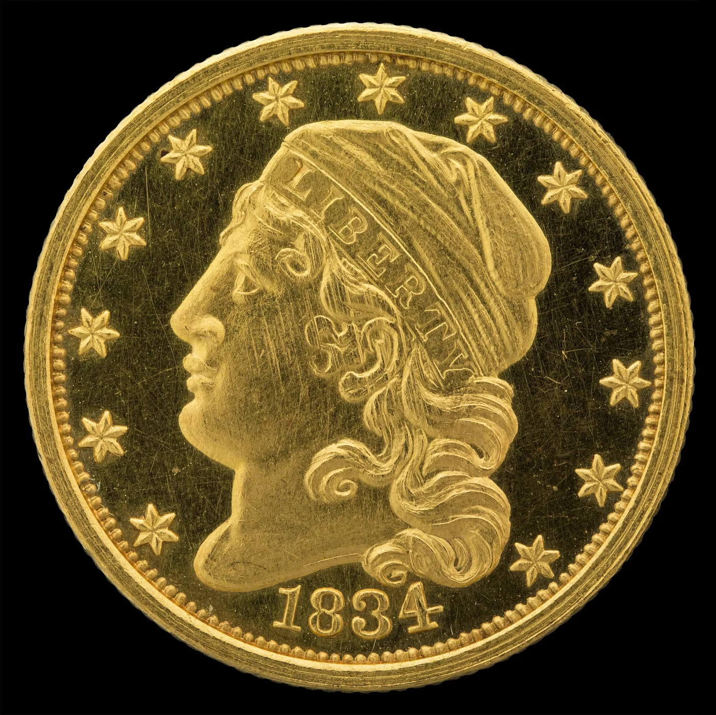 Obverse of an 1834 Capped Head quarter eagle facing left, ringed by stars with the date 1834 below, struck on a reduced-diameter planchet with a fine beaded border