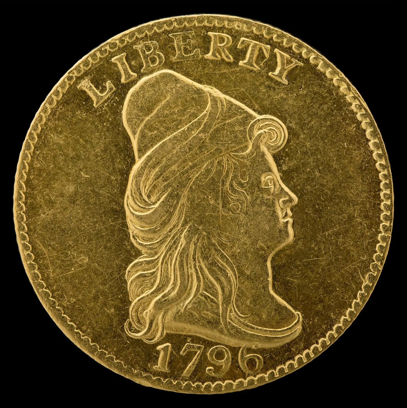 Obverse of an 1796 quarter eagle with a completely plain field, LIBERTY arched above the capped head of Liberty facing right and the date 1796 below