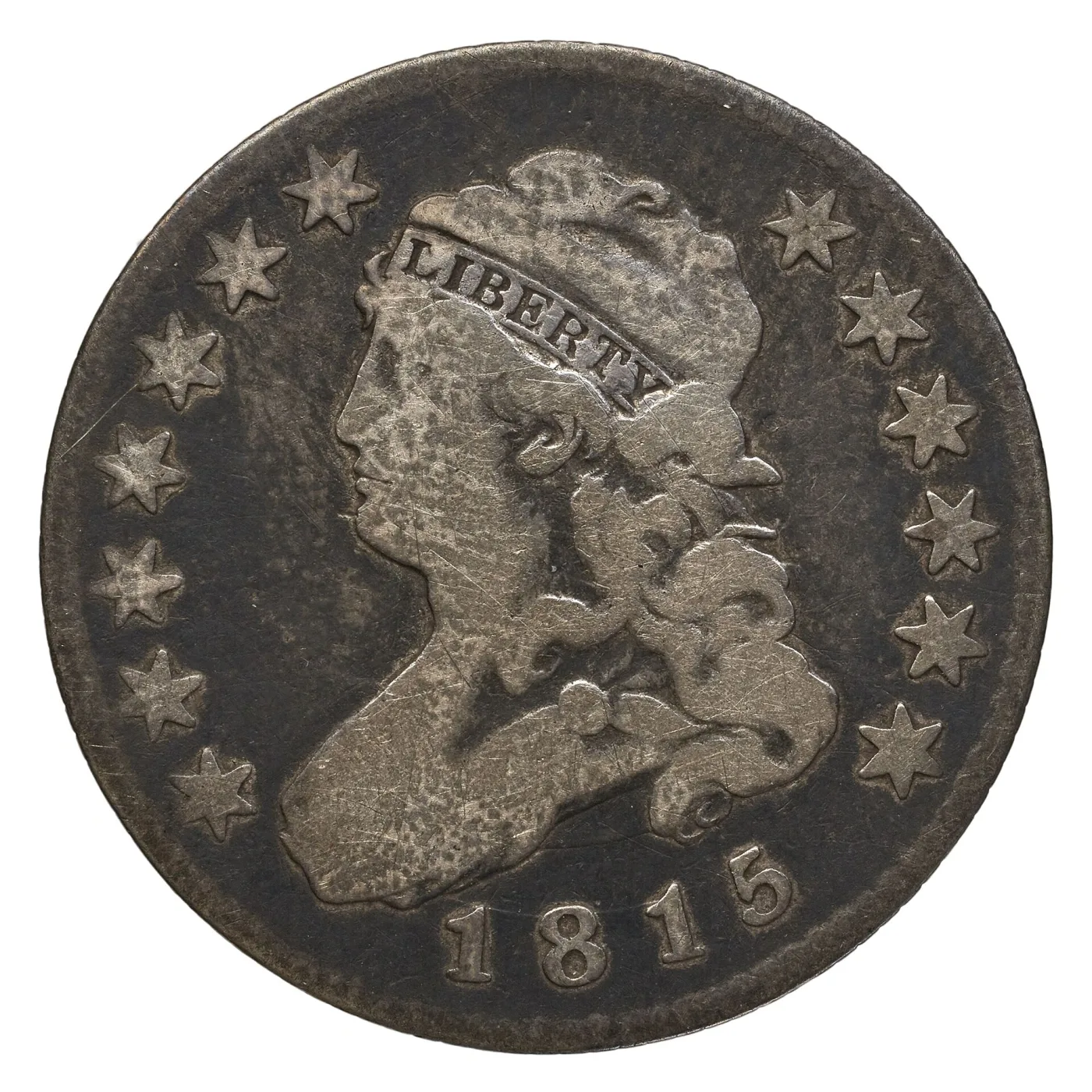 Obverse of a heavily circulated 1815 Capped Bust quarter with the cheek and hair worn flat, LIBERTY still readable on the cap band and 1815 clear below the bust
