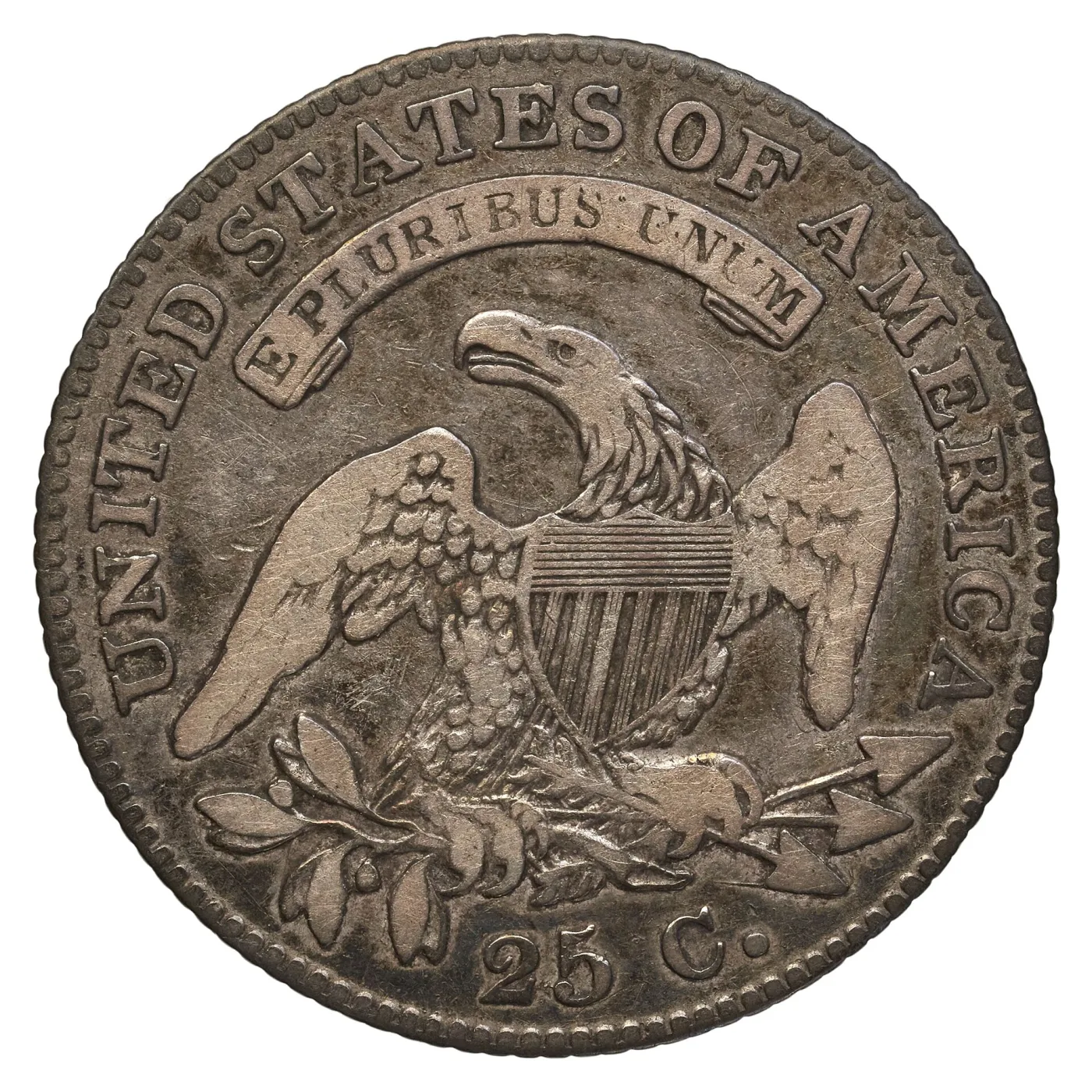 Reverse of an 1828 Capped Bust quarter showing a heraldic eagle with a striped shield on its breast, three arrows in one talon and an olive branch in the other, E PLURIBUS UNUM on a scroll above and 25 C. below