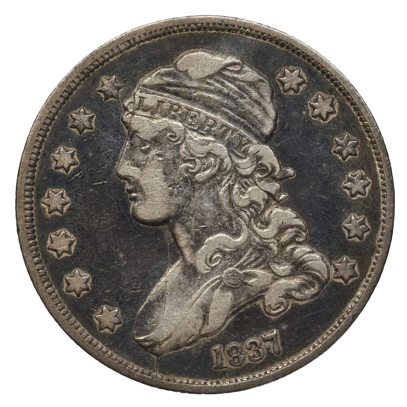 Obverse of an 1837 Capped Bust quarter with LIBERTY complete on the cap band, separated hair curls and 1837 sharp below the bust