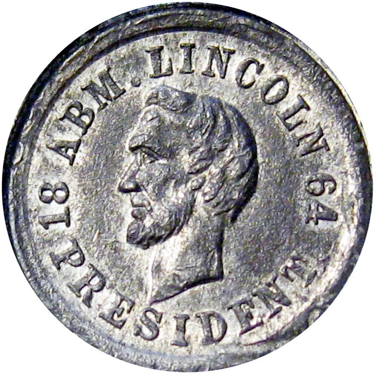 A silvery Civil War era token with a bearded portrait of Abraham Lincoln and the legend 18 ABM. LINCOLN 64 PRESIDENT