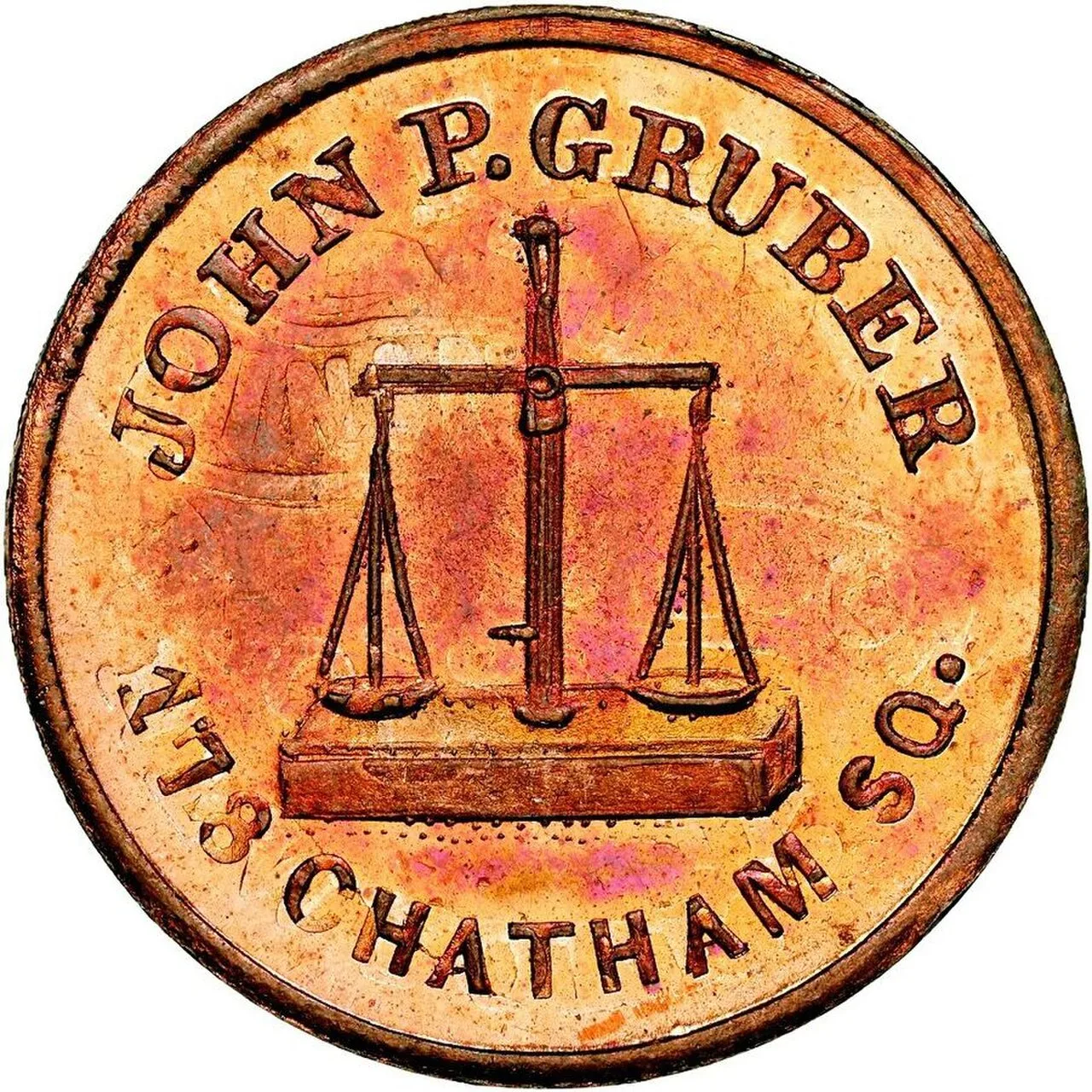 A copper Civil War store card reading JOHN P. GRUBER, 178 CHATHAM SQ., around a set of balance scales