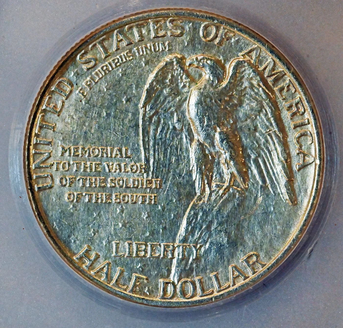 Reverse of the Stone Mountain Memorial half dollar showing an eagle with raised wings on a rocky ledge, with a four-line inscription reading MEMORIAL TO THE VALOR OF THE SOLDIER OF THE SOUTH