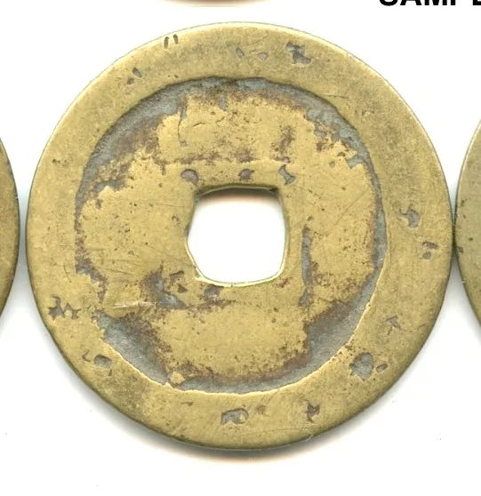 A Chinese cash coin so corroded that the raised characters have been eaten away, leaving an uneven pitted surface