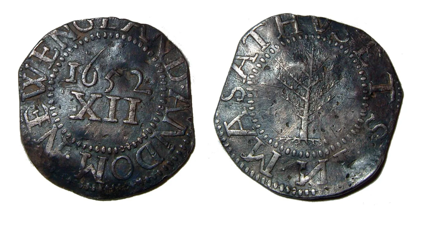 Both sides of a corroded Massachusetts Pine Tree shilling recovered as a metal-detecting find, the tree and the 1652 XII legend still legible