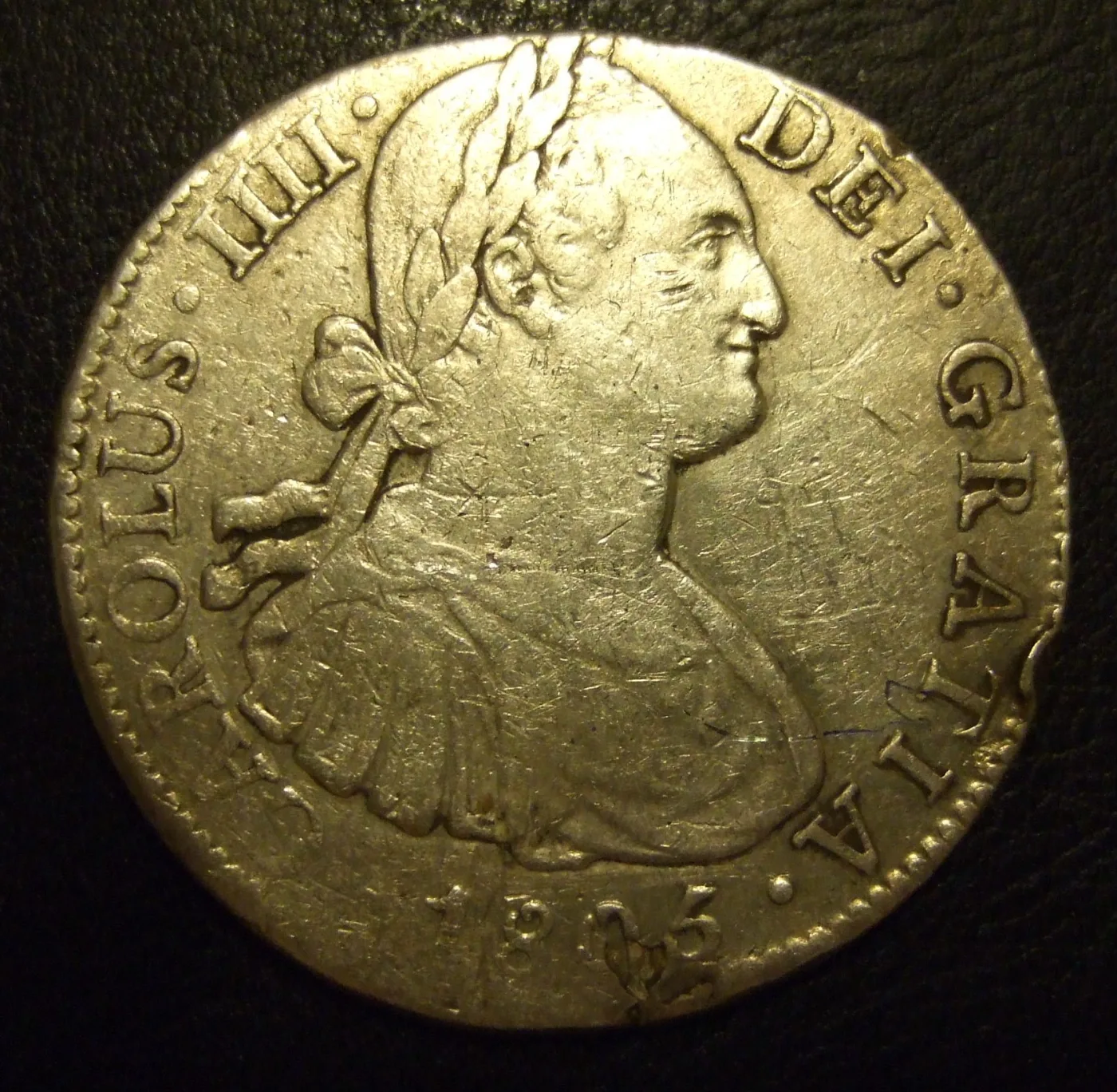 Obverse of an 1805 Spanish eight reales of Carlos IIII struck at the Mexico City mint, showing the laureate royal bust facing right