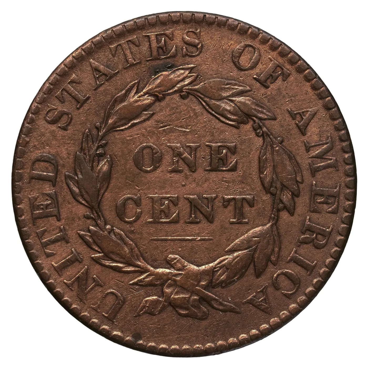 Reverse of an 1823 Coronet Head large cent showing ONE CENT inside a wreath, UNITED STATES OF AMERICA around the border and a short bar beneath CENT