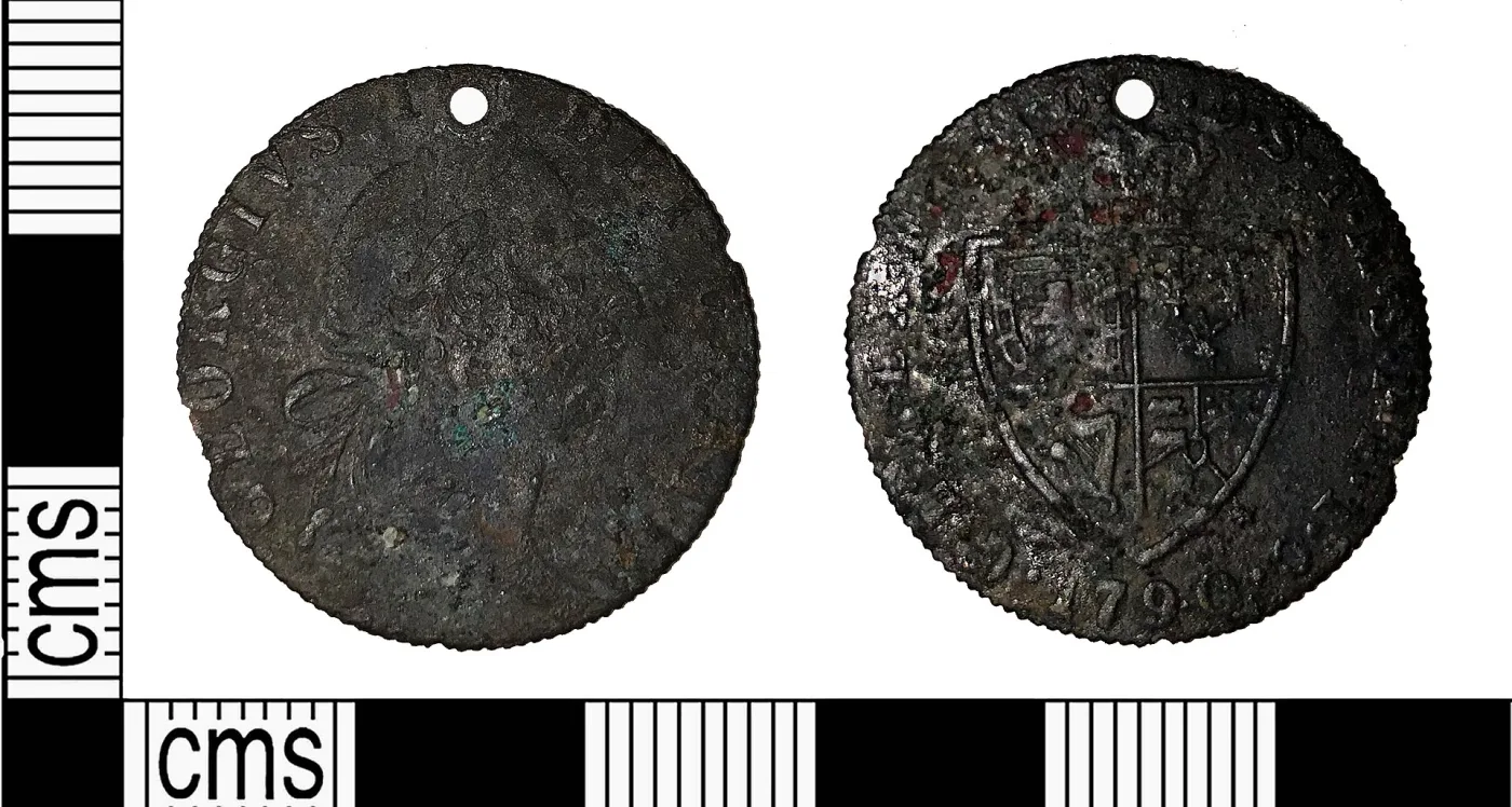 Two faces of a worn brass-coloured token imitating a half guinea, the design nearly smooth