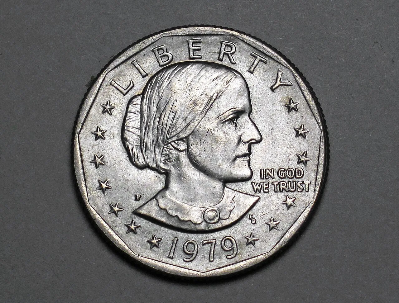 Obverse of a circulated 1979 Susan B. Anthony dollar, her portrait facing right inside an eleven-sided border, LIBERTY above and a P mint mark at left