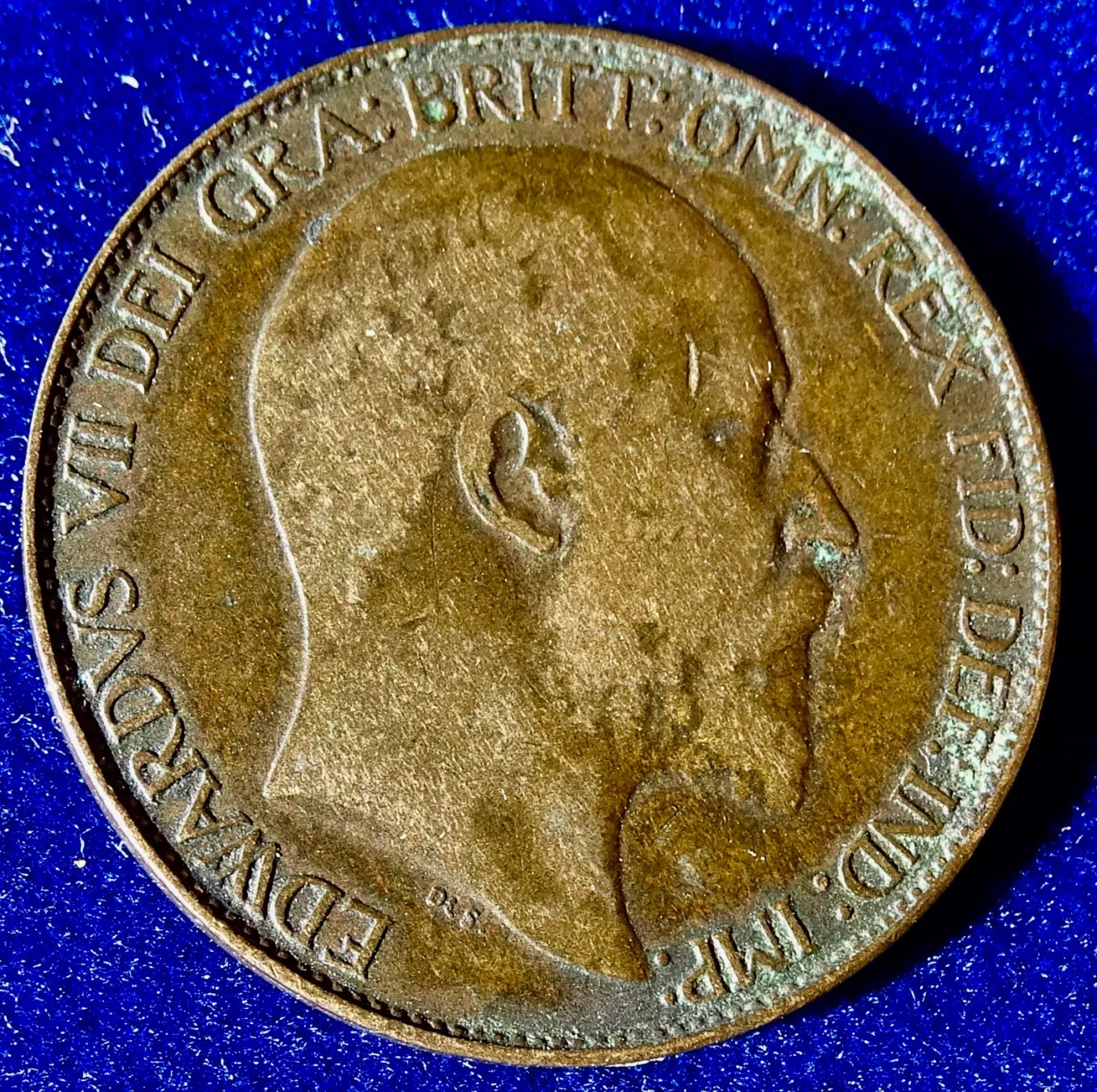 One face of a British halfpenny showing a portrait of Edward VII with the legend EDWARDVS VII DEI GRA BRITT OMN REX FID DEF IND IMP