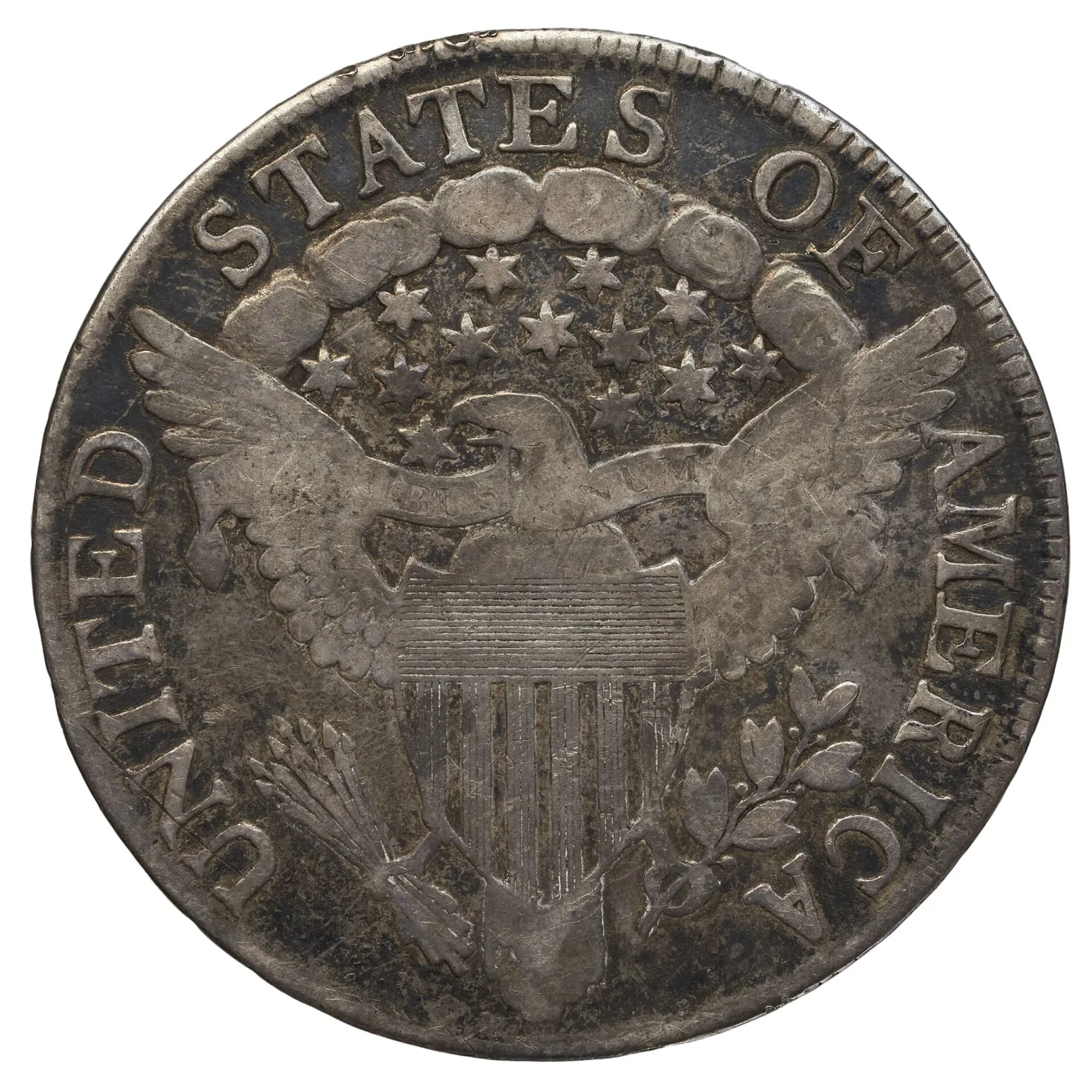Well-worn Heraldic Eagle reverse of a Draped Bust half dollar, the shield stripes still countable but the E PLURIBUS UNUM ribbon lettering largely rubbed away