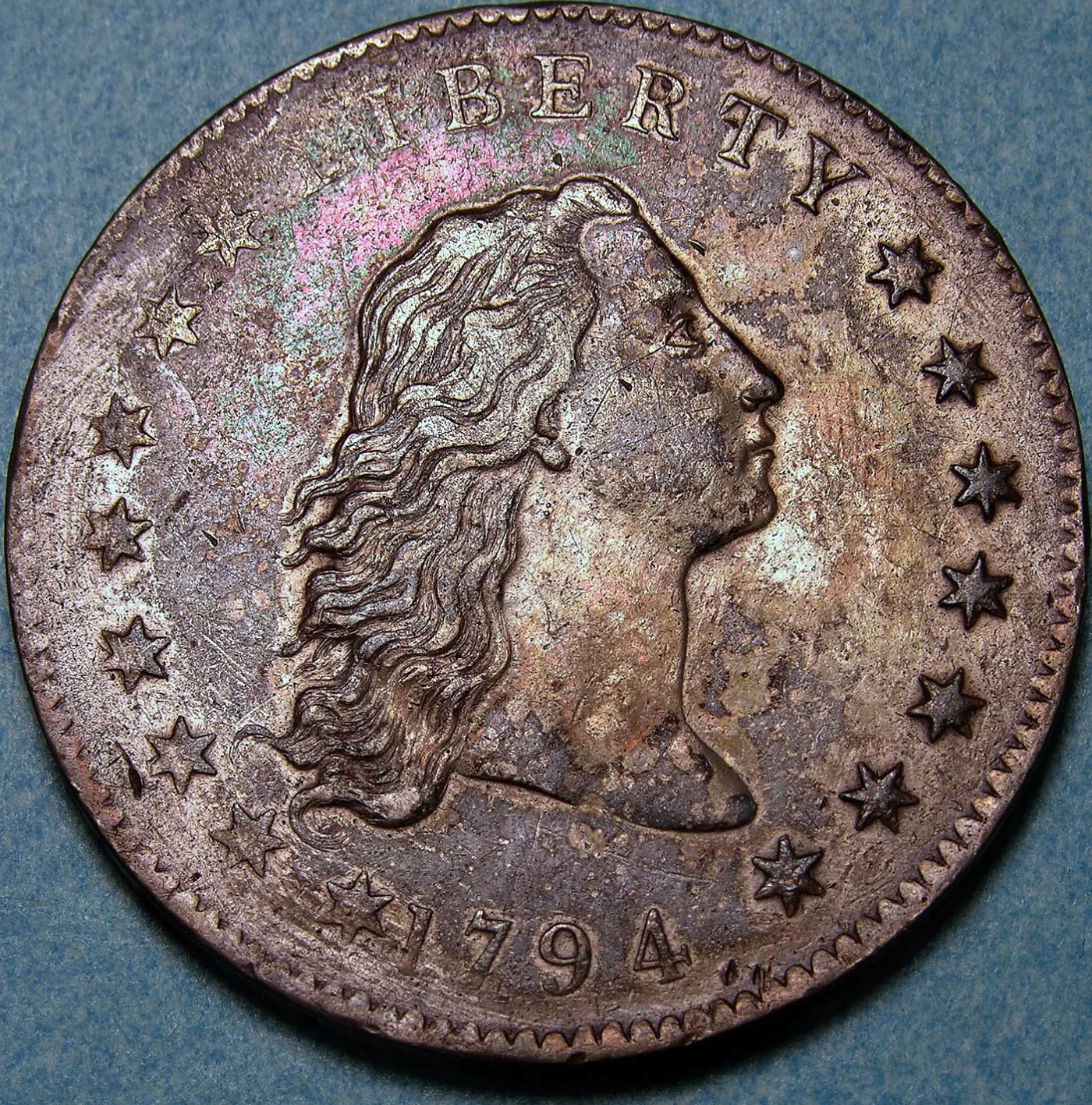 Obverse of a 1794 Flowing Hair dollar with the date 1794 below the bust and softly impressed detail on the left side of the field