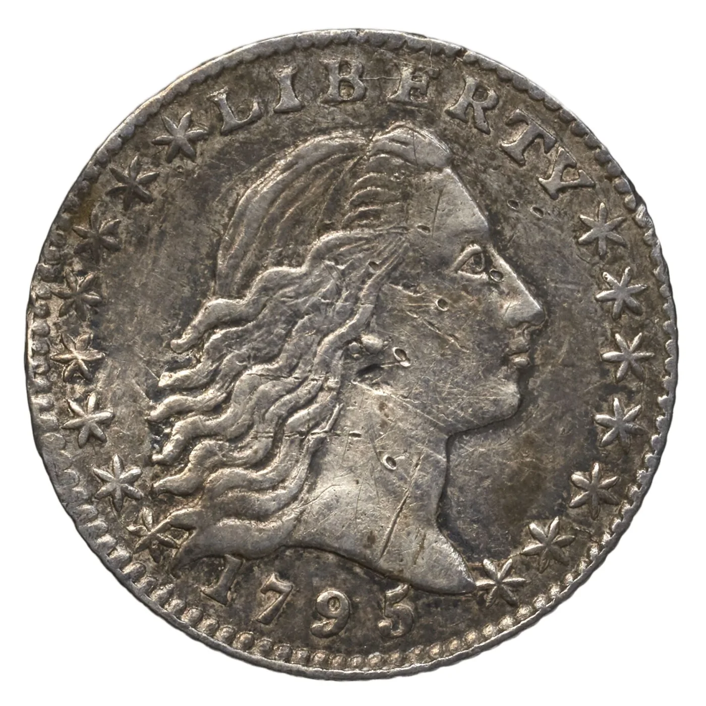 Obverse of a 1795 Flowing Hair half dime showing Liberty facing right with loose hair, LIBERTY above and fifteen stars around the portrait
