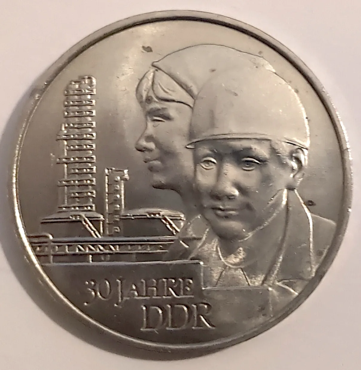 Reverse of the same 1979 East German 20 Mark showing two workers in caps in front of an industrial plant, inscribed 30 JAHRE DDR