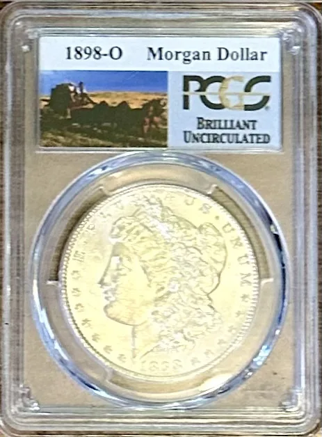 An 1898-O Morgan dollar in an early PCGS holder whose label reads Brilliant Uncirculated with no numerical grade