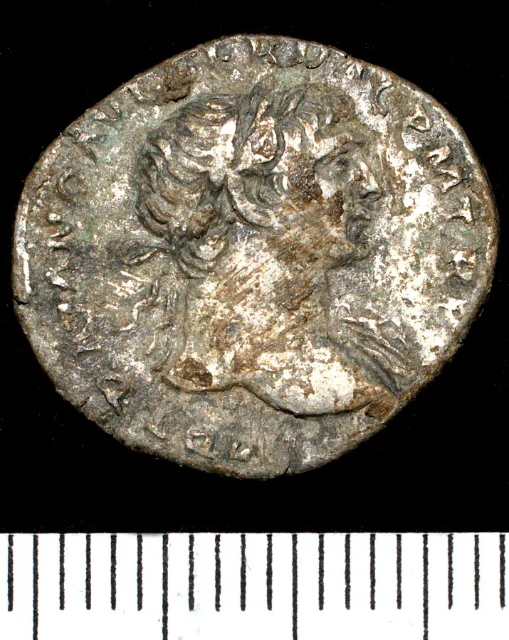 Obverse of a Roman silver denarius showing a laureate head facing right with an abbreviated Latin legend around it