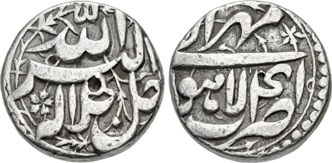 Silver rupee of the Mughal emperor Akbar struck at Lahore, showing Persian calligraphy filling both faces with no portrait or emblem