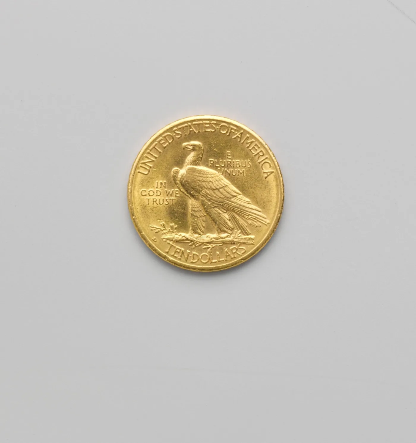 Reverse of a 1910-D Indian Head eagle with a small D mint mark to the left of the arrow bundle, above TEN DOLLARS