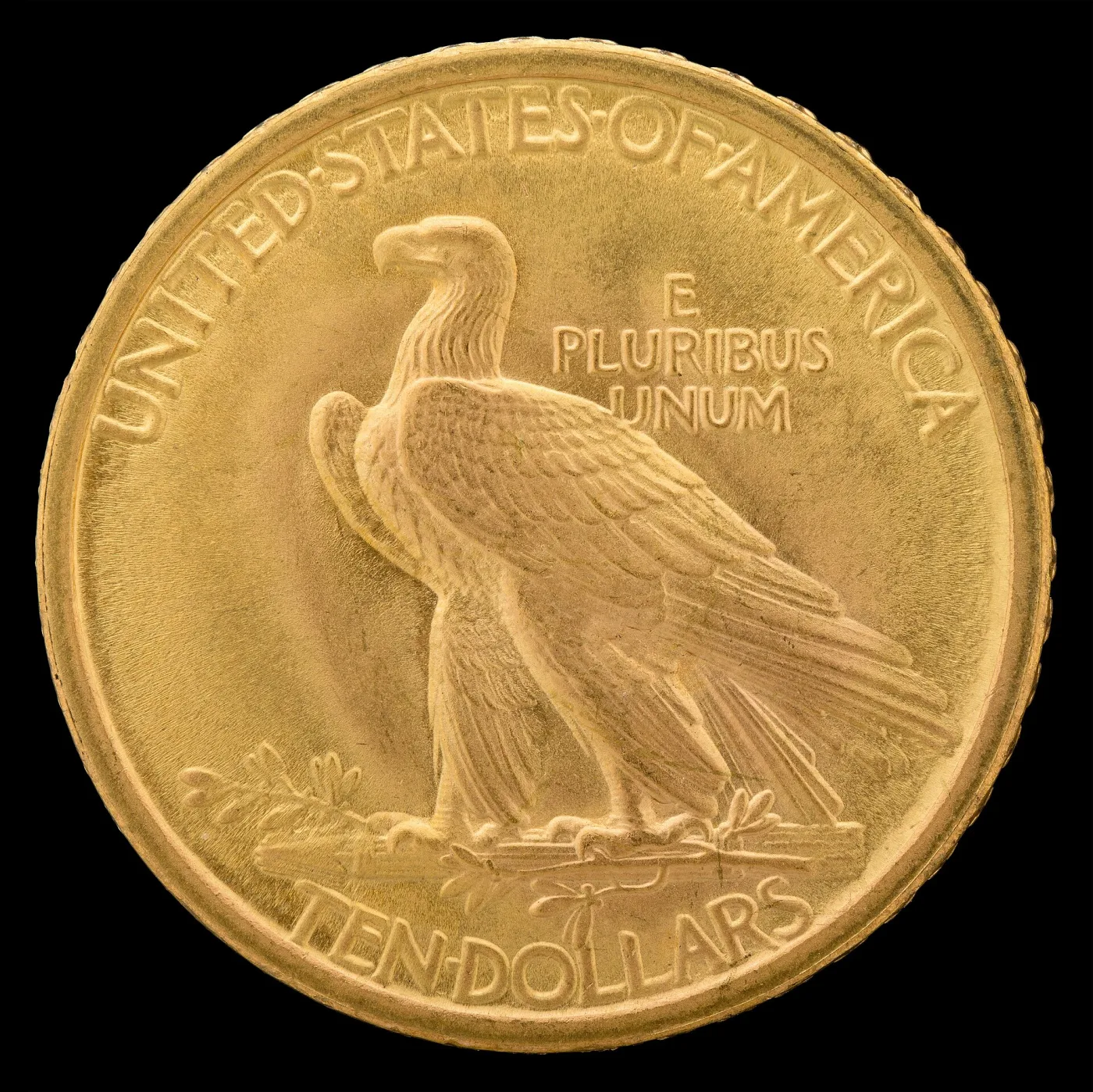 Reverse of a 1907 No Motto Indian Head eagle: standing eagle on arrows and olive branch, E PLURIBUS UNUM at right, empty field at left