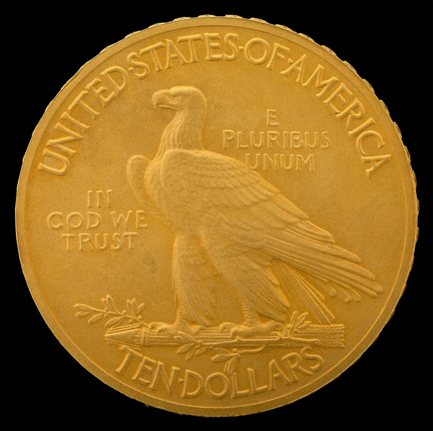 Close view of a 1908 Indian Head eagle reverse with IN GOD WE TRUST in three lines to the left of the eagle