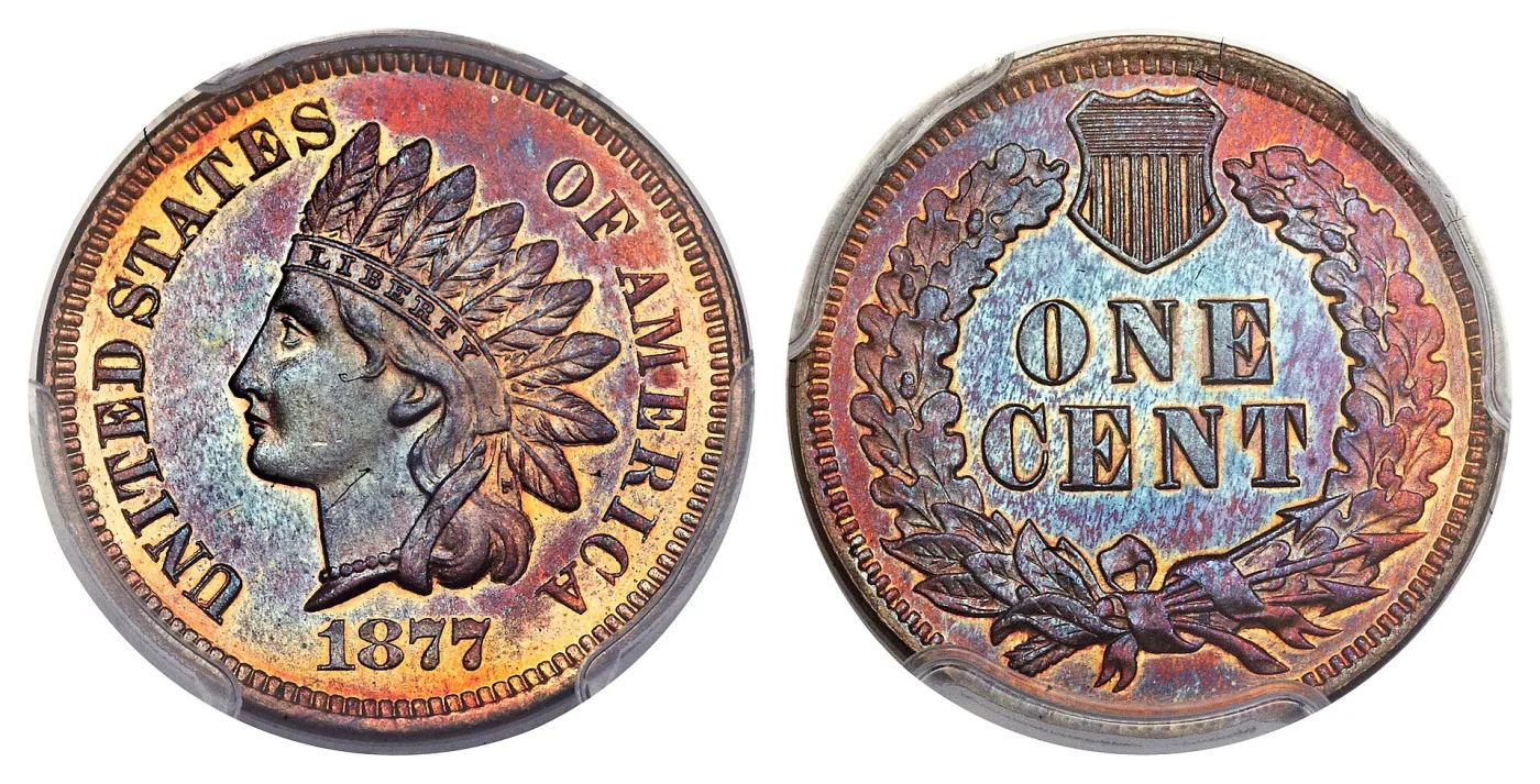 Obverse and reverse of an 1877 Indian Head cent, a deeply toned proof photographed inside a sealed grading holder