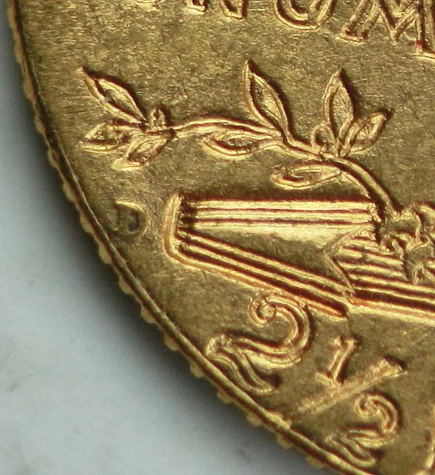 Magnified view of the mint mark area on a 1911-D Indian Head quarter eagle reverse, the incuse D standing in the band of field between the beaded rim and the left end of the arrow bundle, with the 2 and a half of the denomination below