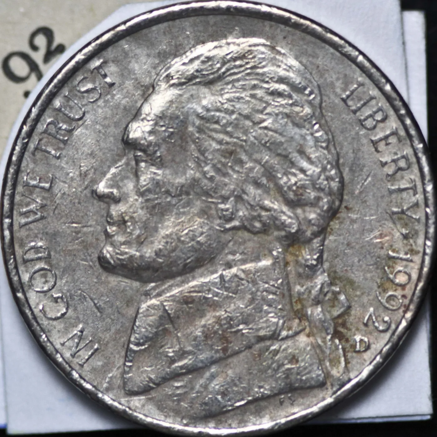 Close view of the obverse of a 1992-D Jefferson nickel with the D mint mark punched below the date near the rim