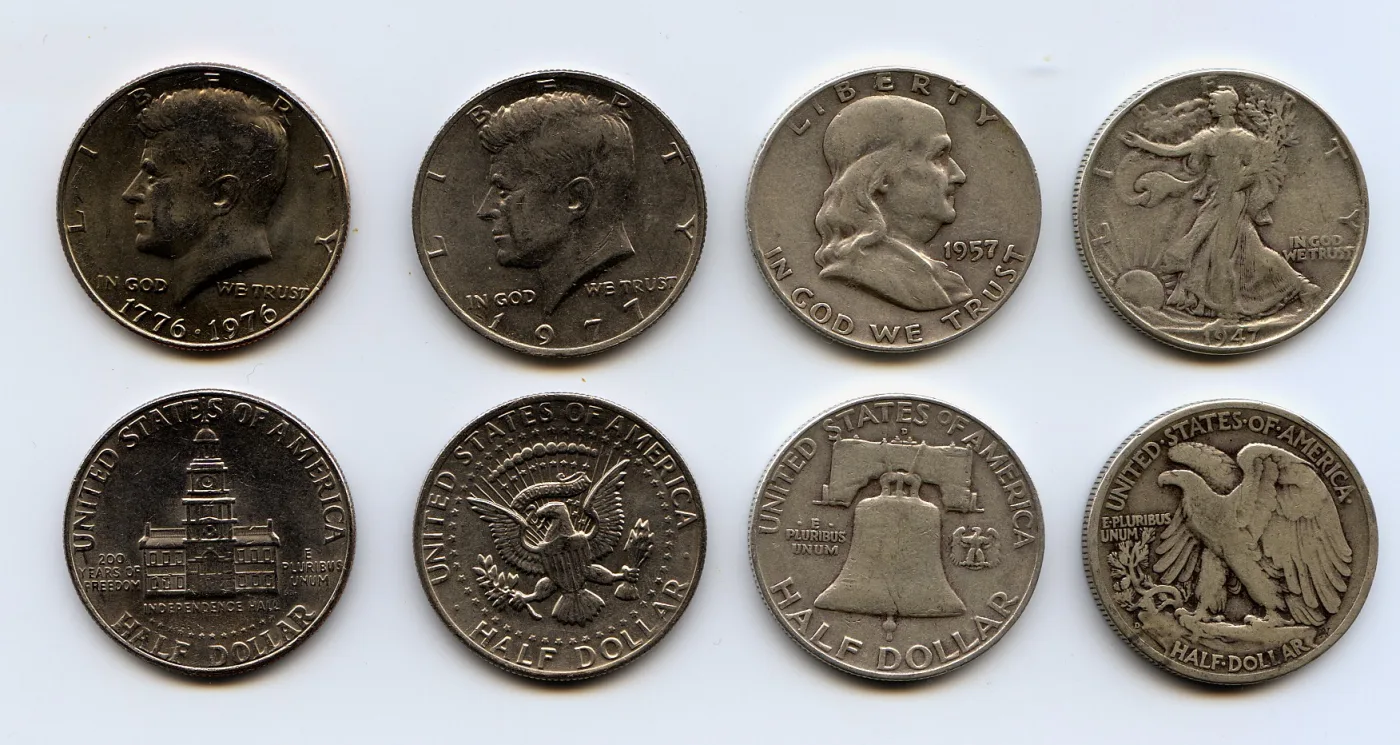 Four US half dollar types shown obverse and reverse: a 1776-1976 Bicentennial Kennedy, a 1977 Kennedy, a 1957 Franklin and a 1947 Walking Liberty