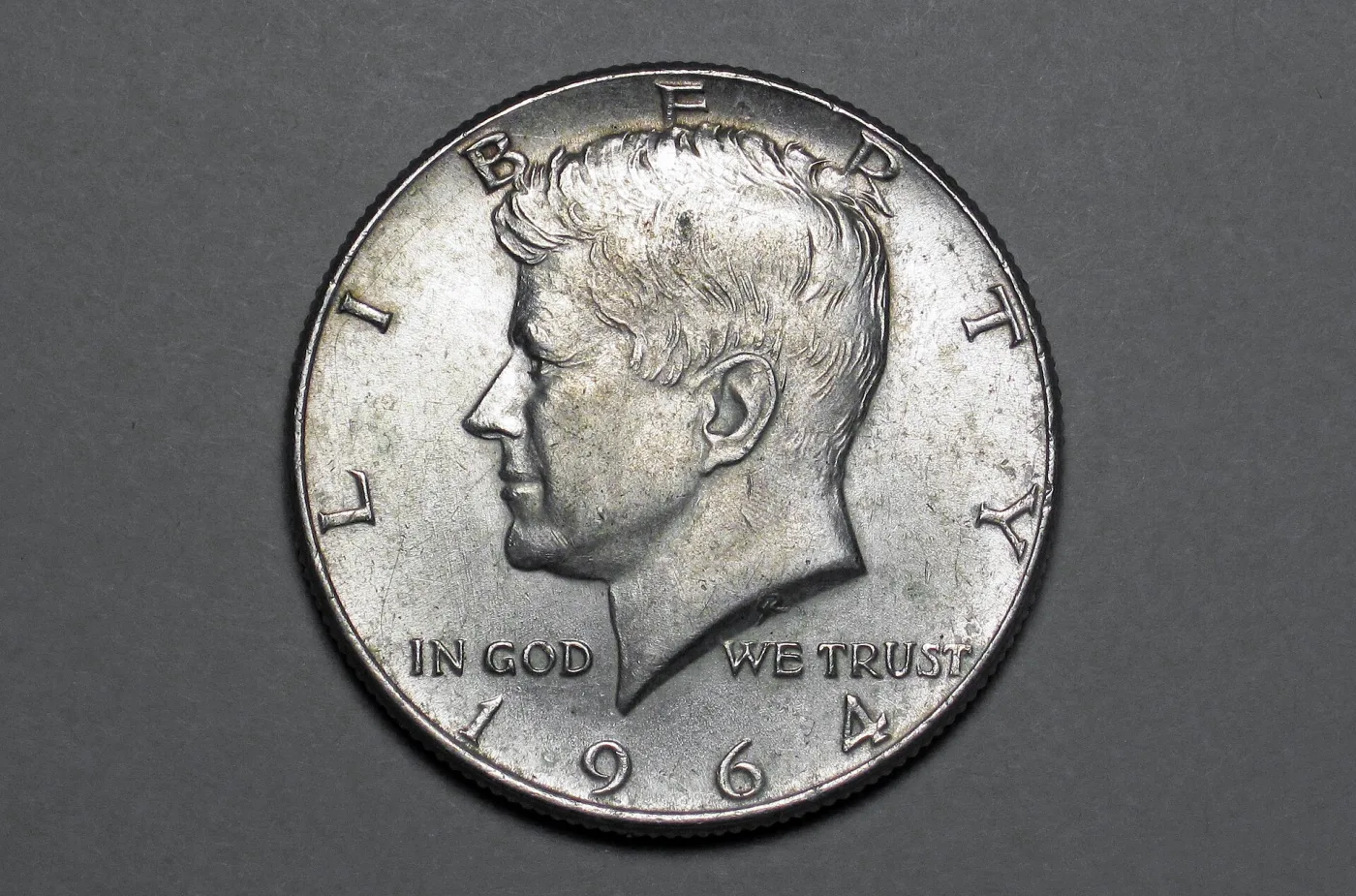 Obverse of a 1964 Kennedy half dollar, the first-year 90 percent silver issue, with no mint mark above the date