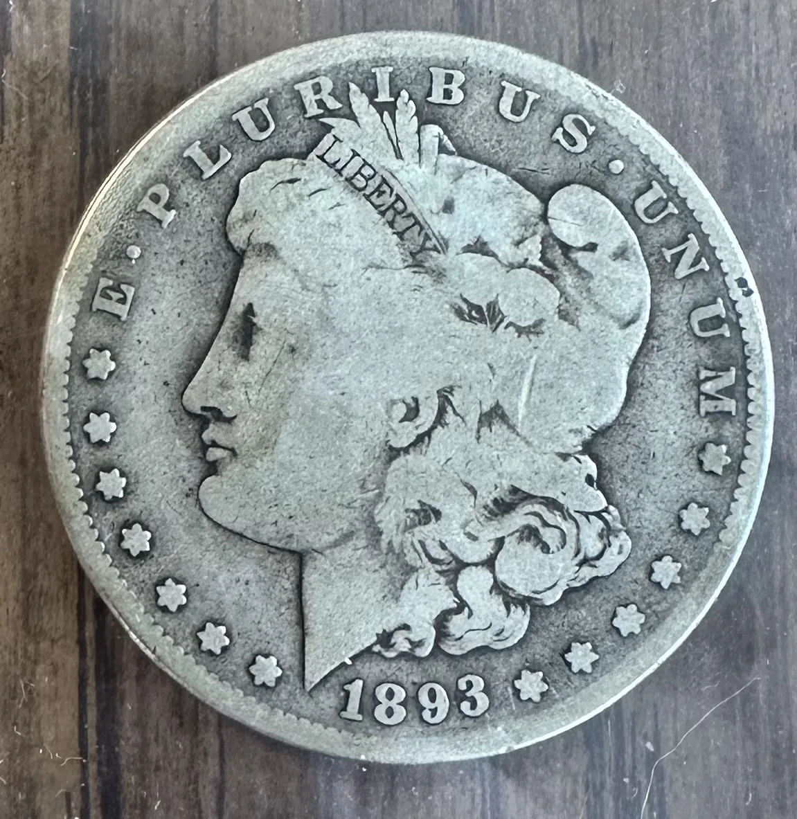 Obverse of an 1893-S Morgan silver dollar showing Liberty facing left with the date 1893 below