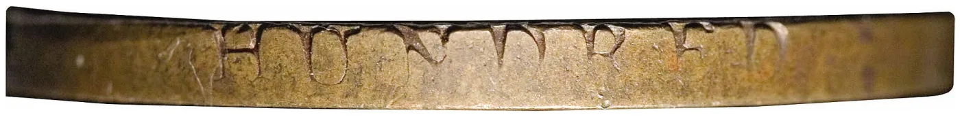 Close-up of the lettered edge of a 1794 Liberty Cap large cent, photographed square-on, with the letters HUNDRED clearly legible