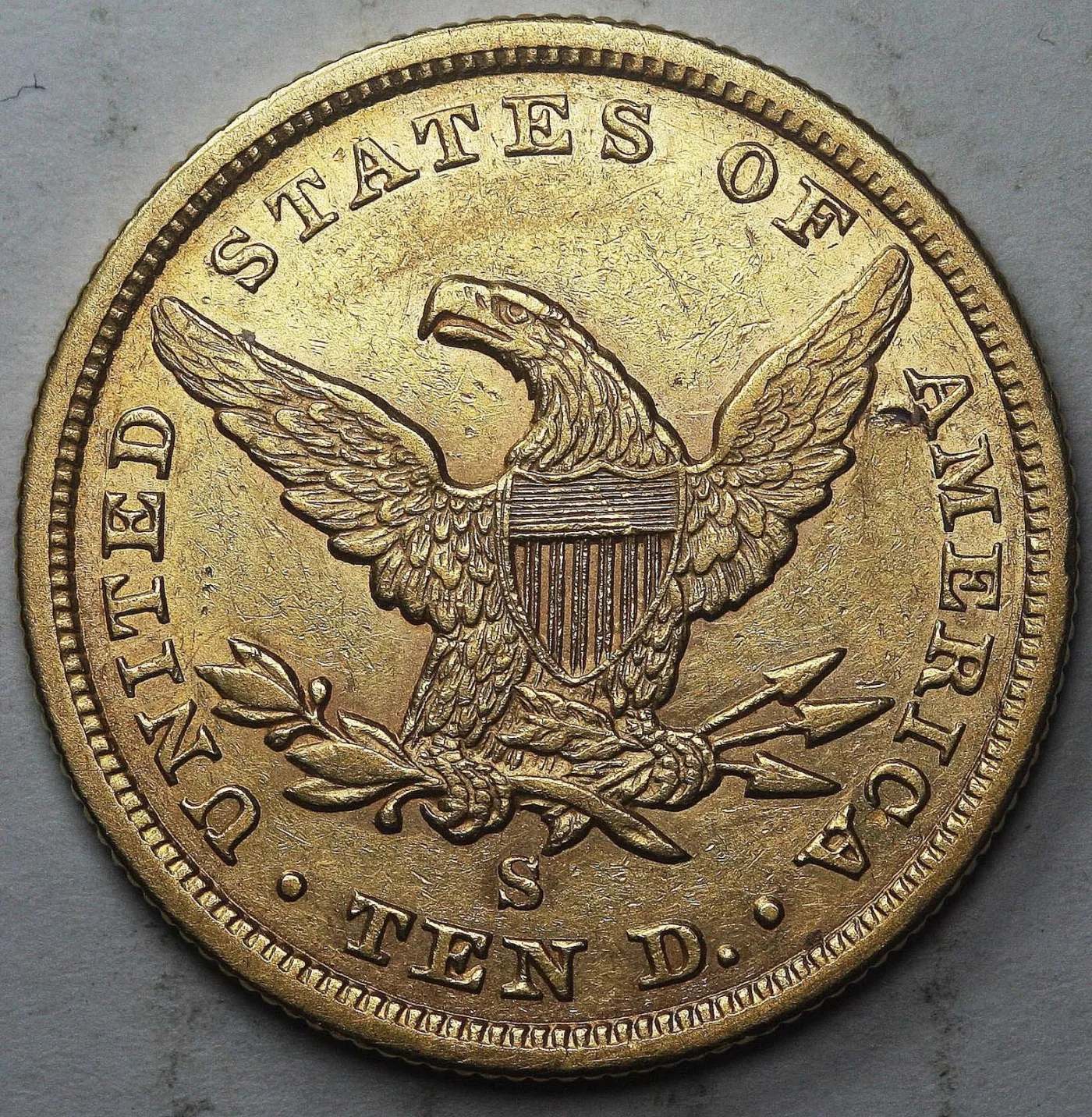 Reverse of an 1856-S Liberty Head Eagle with a plain field above the eagle's head, an S mint mark below the eagle and TEN D. at the bottom