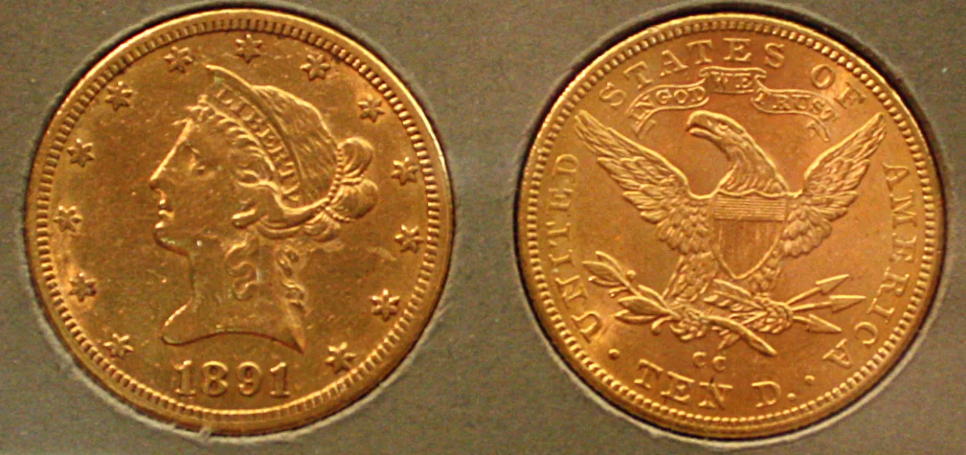 Obverse and reverse of an 1891-CC Liberty Head Eagle, the reverse carrying the IN GOD WE TRUST scroll above the eagle, the CC mint mark below it and TEN D. at the bottom