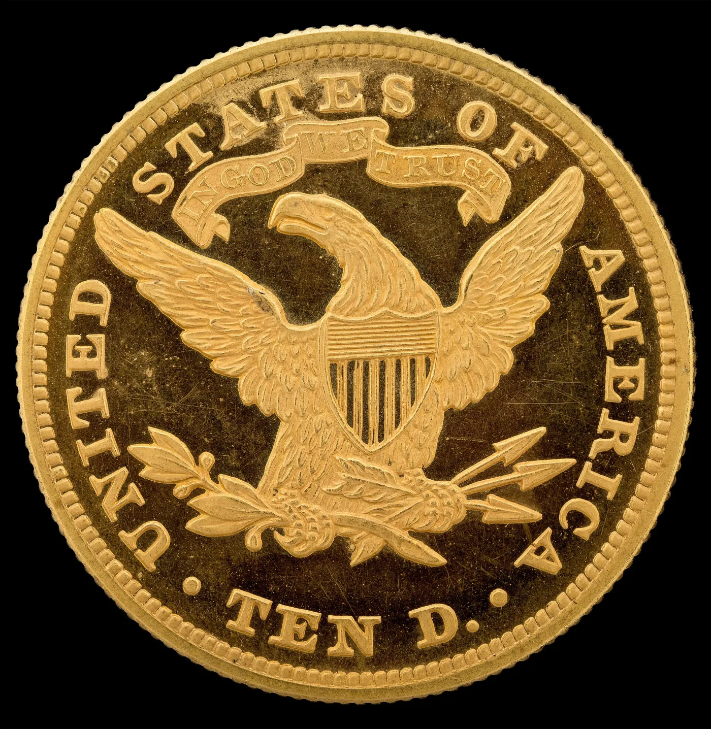 Close view of the reverse of an 1866 Liberty Head Eagle proof, the IN GOD WE TRUST scroll filling the space above the eagle's head