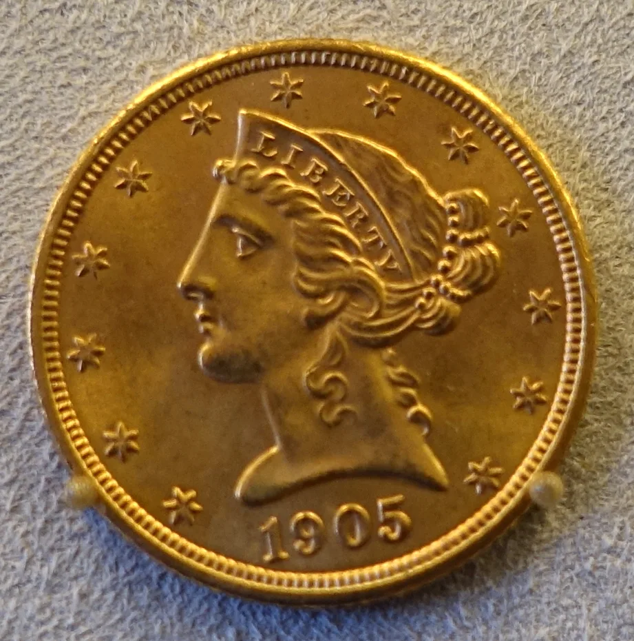 Obverse of a 1905 Liberty Head Half Eagle displayed in a museum mount, showing the coronet portrait, thirteen stars and the date 1905
